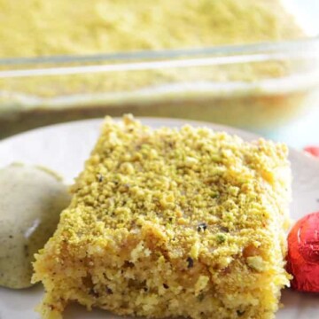 A piece of cake on a plate, with Pistachio and Semolina