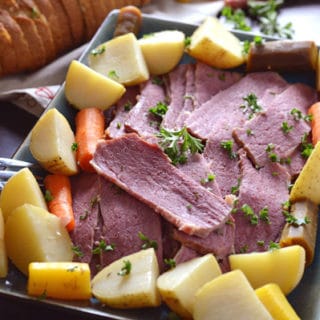 A plate of food with with corned Beef and potatoes