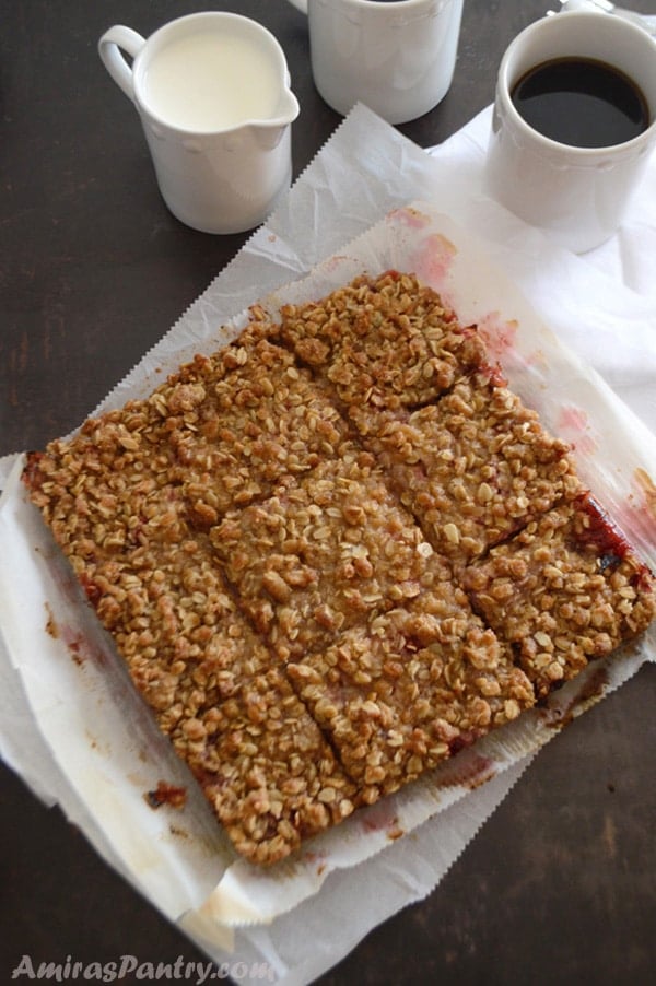 A close up of a plate of food with crumbled rhubarb bars