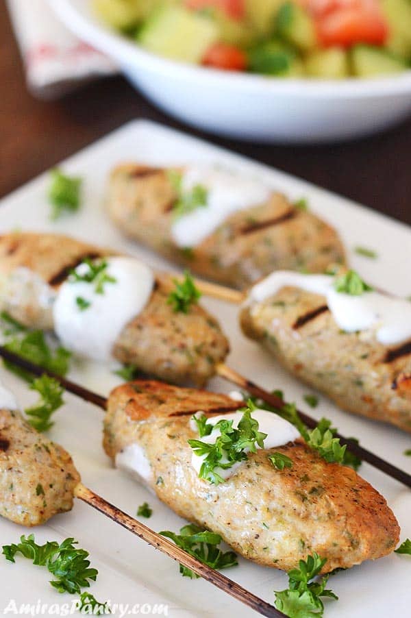 A plate of food, with Chicken Kofta skewers