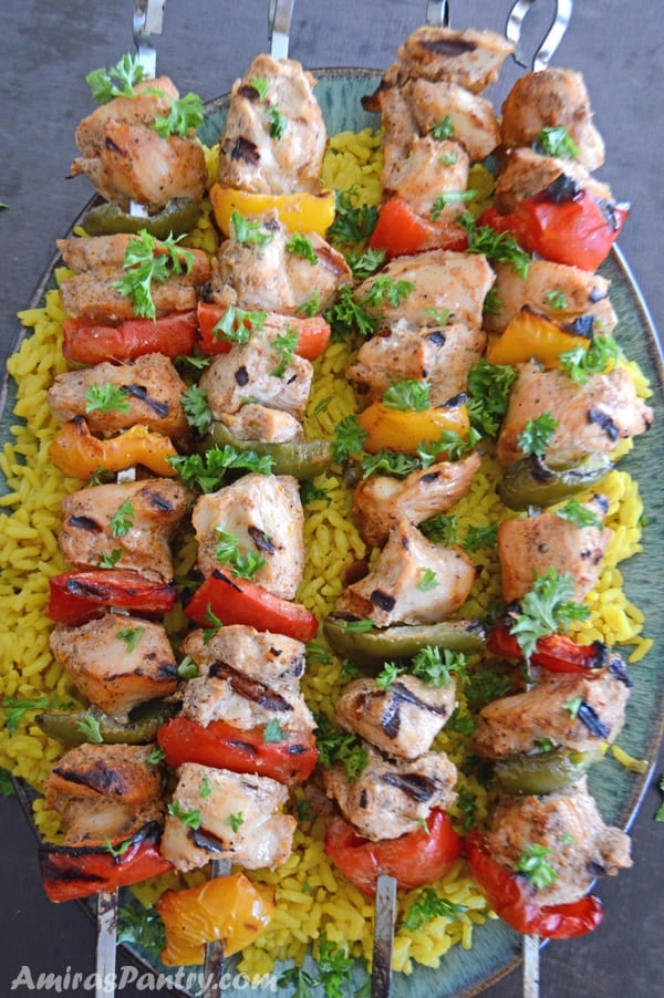 An infograph showing different food photos with Chicken kabob skewers on a plate