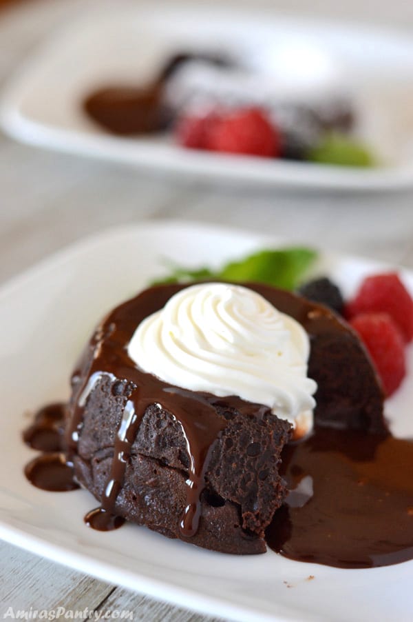 A close up of a piece of chocolate cake on a plate, with Cream