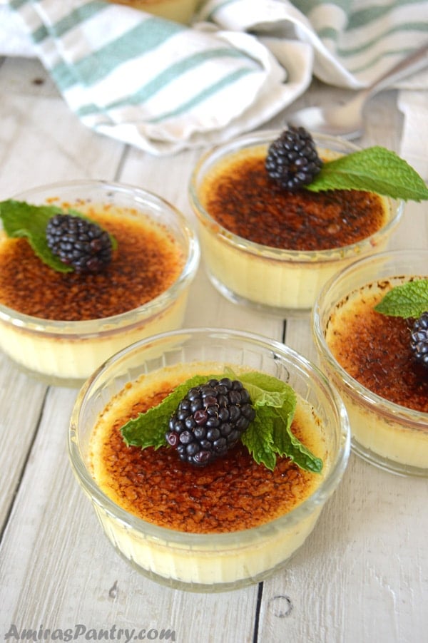 A close up of creme brulee in cups with berries