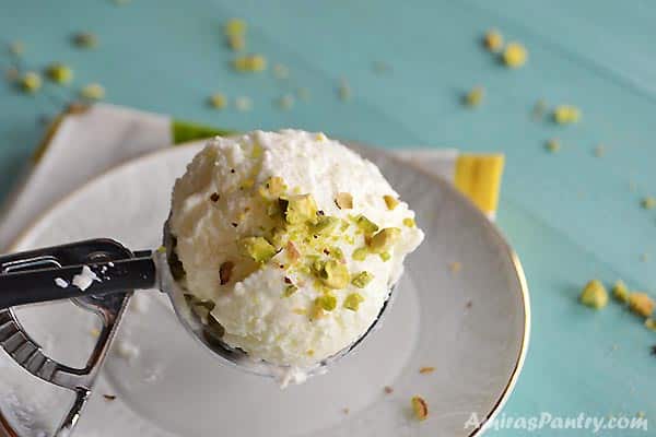 A close up for a scoop of Lebanese milk ice cream called booza with pistachios.
