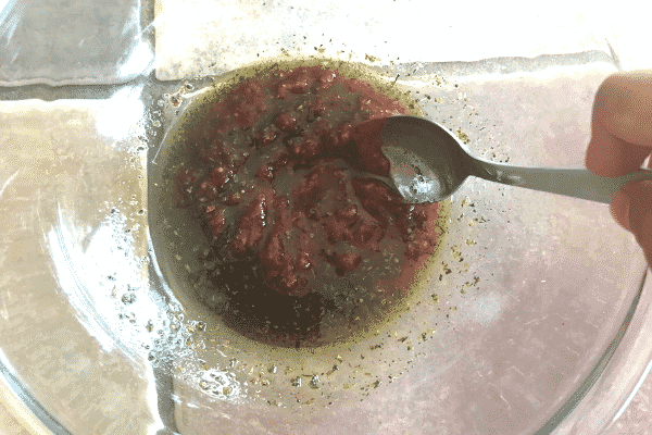 A close up of a plate of food and a spoon, for marination