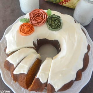 A pumpkin cake photo on a plate with frosting on top