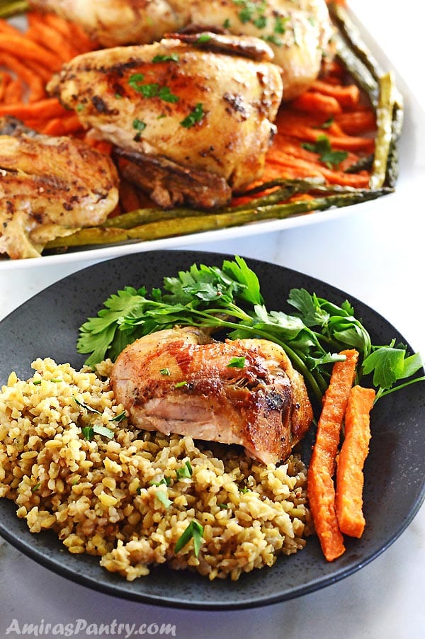 A plate of food with rice, chicken and vegetables