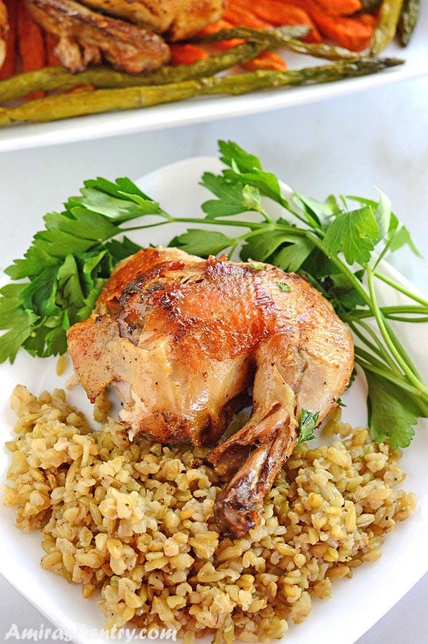 A plate of food with rice, chicken and vegetables