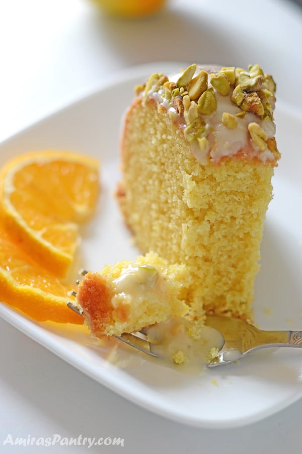 A piece of orange cake on a plate, with Orange