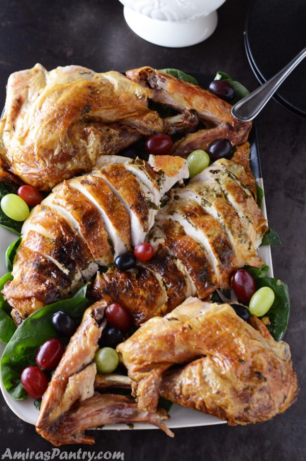 Perfectly roasted and moist turkey carved and served on a large platter.