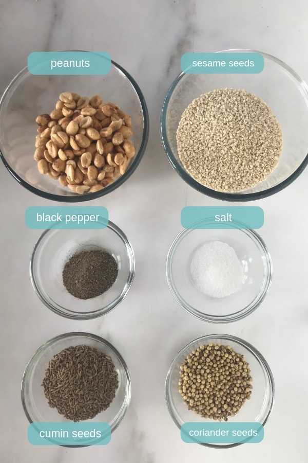Dukka spice ingredients in bowls on a white table