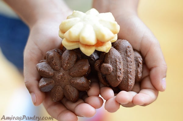 A photo of hands holding up betefour dessert cookies