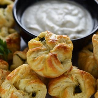 A plate of food, with Spanakopita and dip