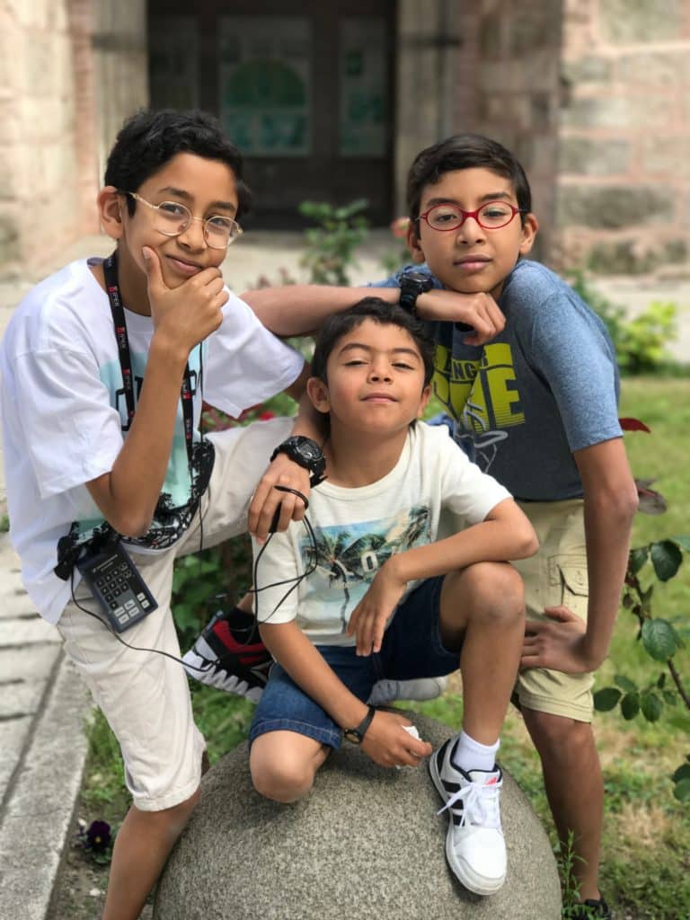 Kids standing together infront of a building