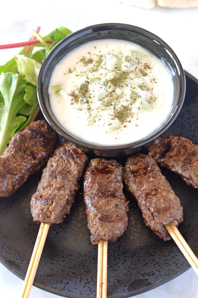 A plate of kofta in skewers and dip