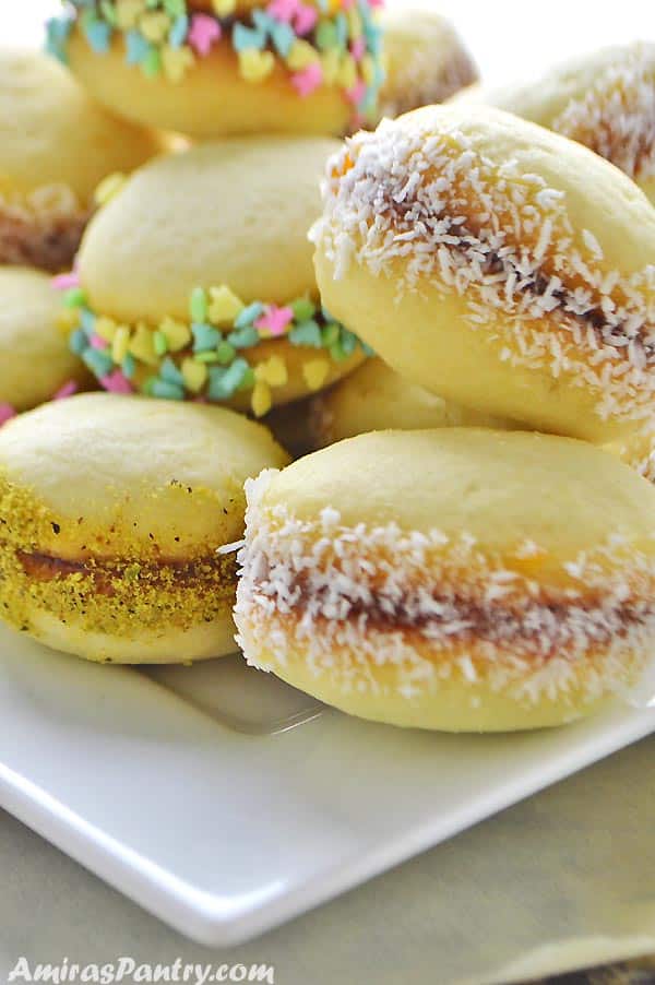 A white plate with lancashire cookies stacked on top of each other.