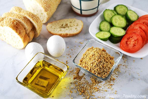 A photo showing Duakkh spice in a bowl, vegetables, oil, eggs and bread