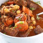 A bowl of food with Beef stew and carrots