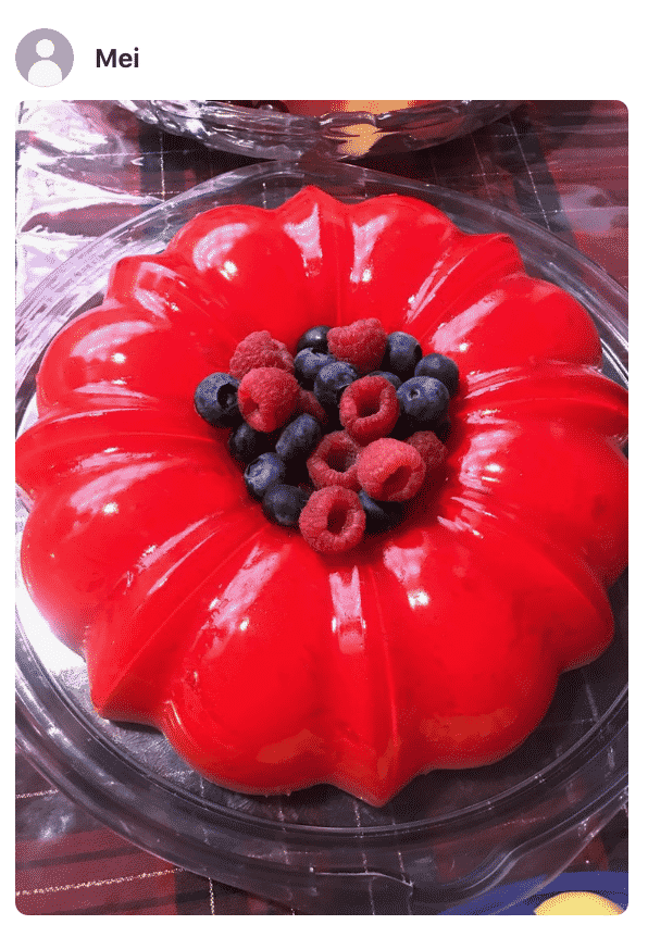 A close up photo of cream jello Cake on a plate, made by a fan