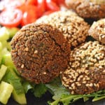A close up of food Falafel on a plate with vegetables