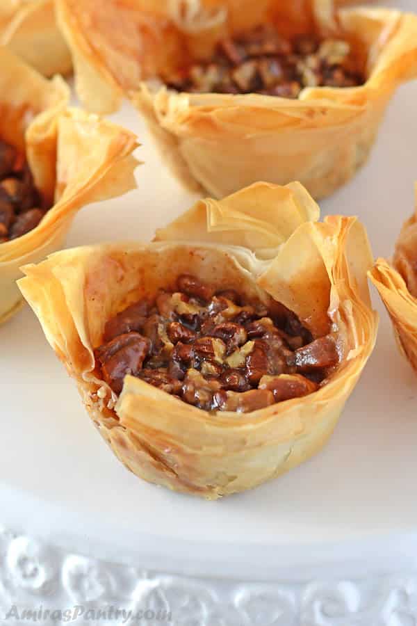 Phyllo pastry cups filled with traditional pecan pie. Take pecan