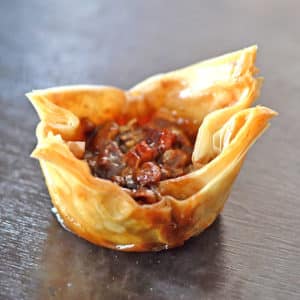 A closeup of mini pecan pie on a plate