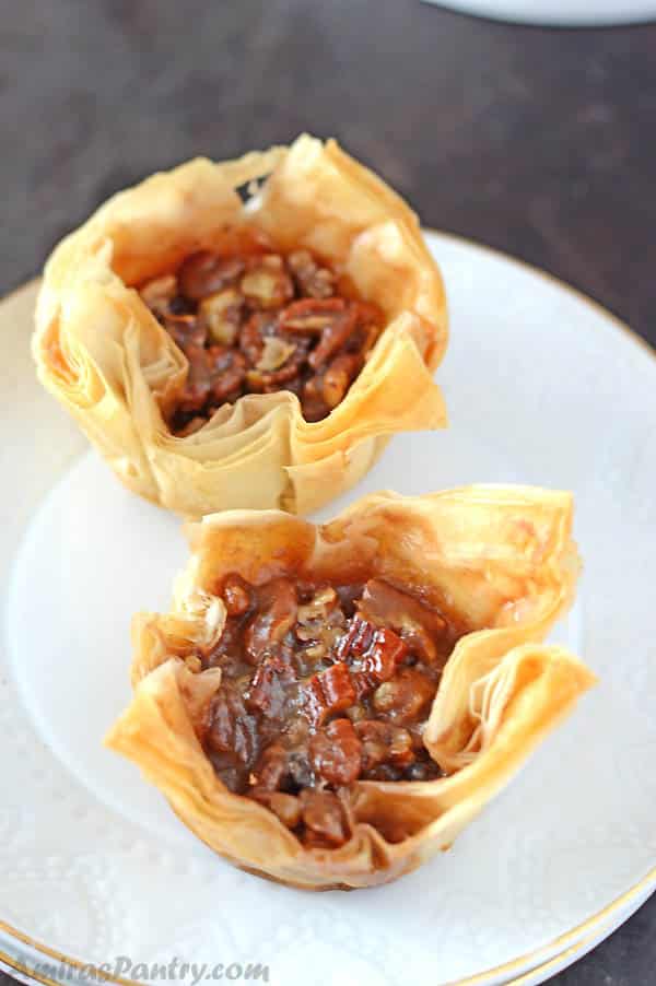 A closeup of mini pecan pies on a plate