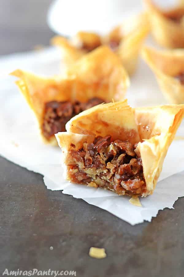 A closeup of mini pecan pie, cut on a plate