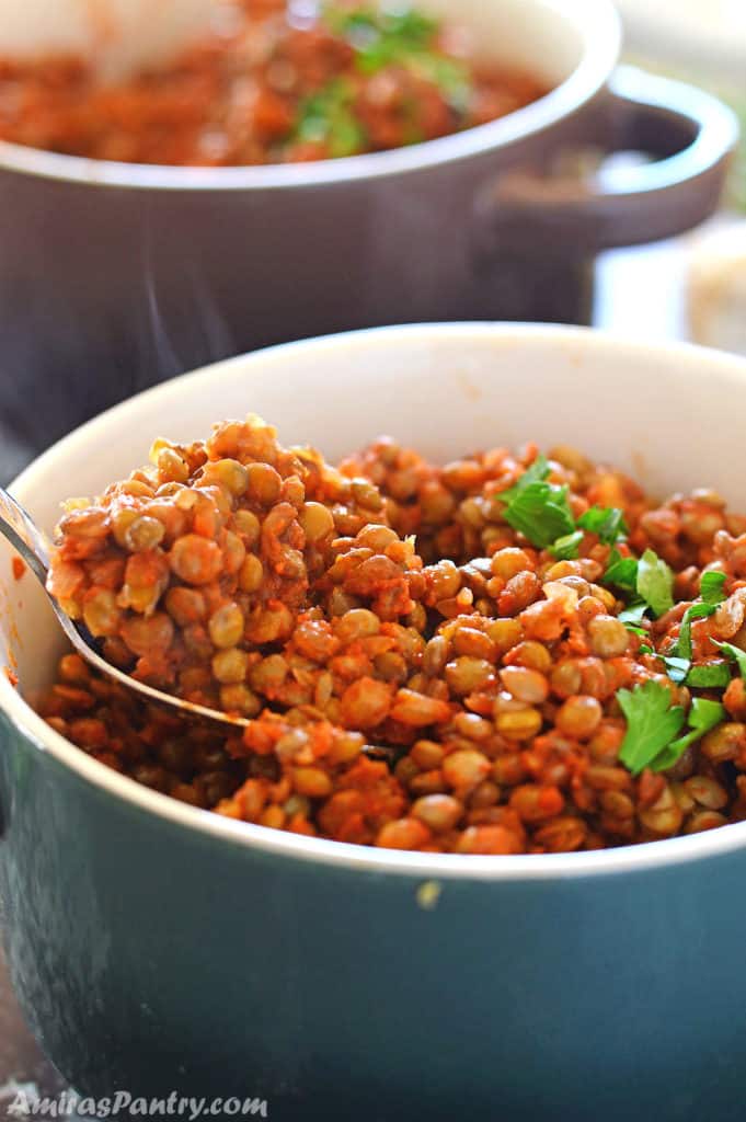 A bowl of food on a table, with Lentil and vegetables