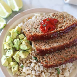 A plate of food, with Meatloaf, rice and guacamole