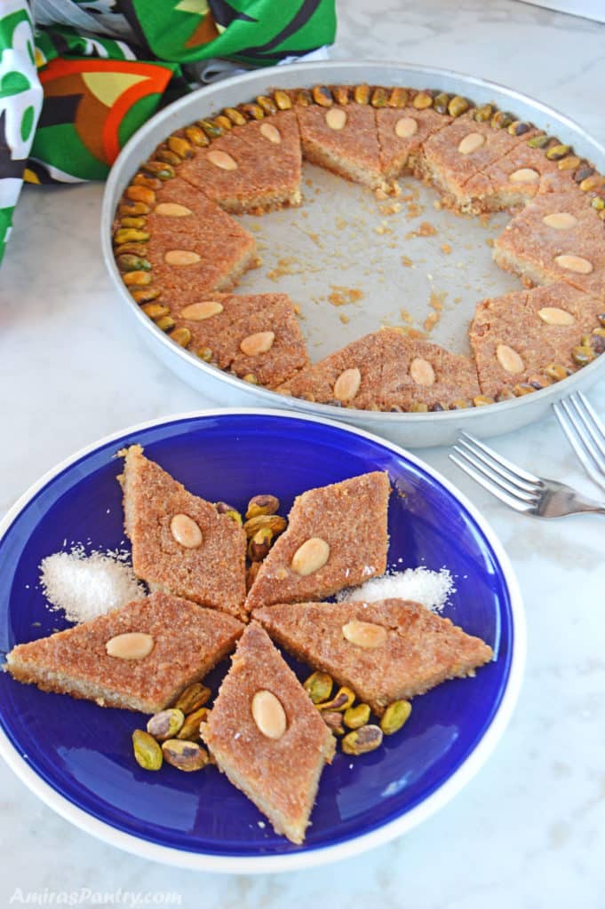 pieces of semolina cake on a blue plate with the whole baking dish on the back