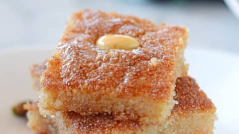 basboosa squares stacked on top of each other on a white plate