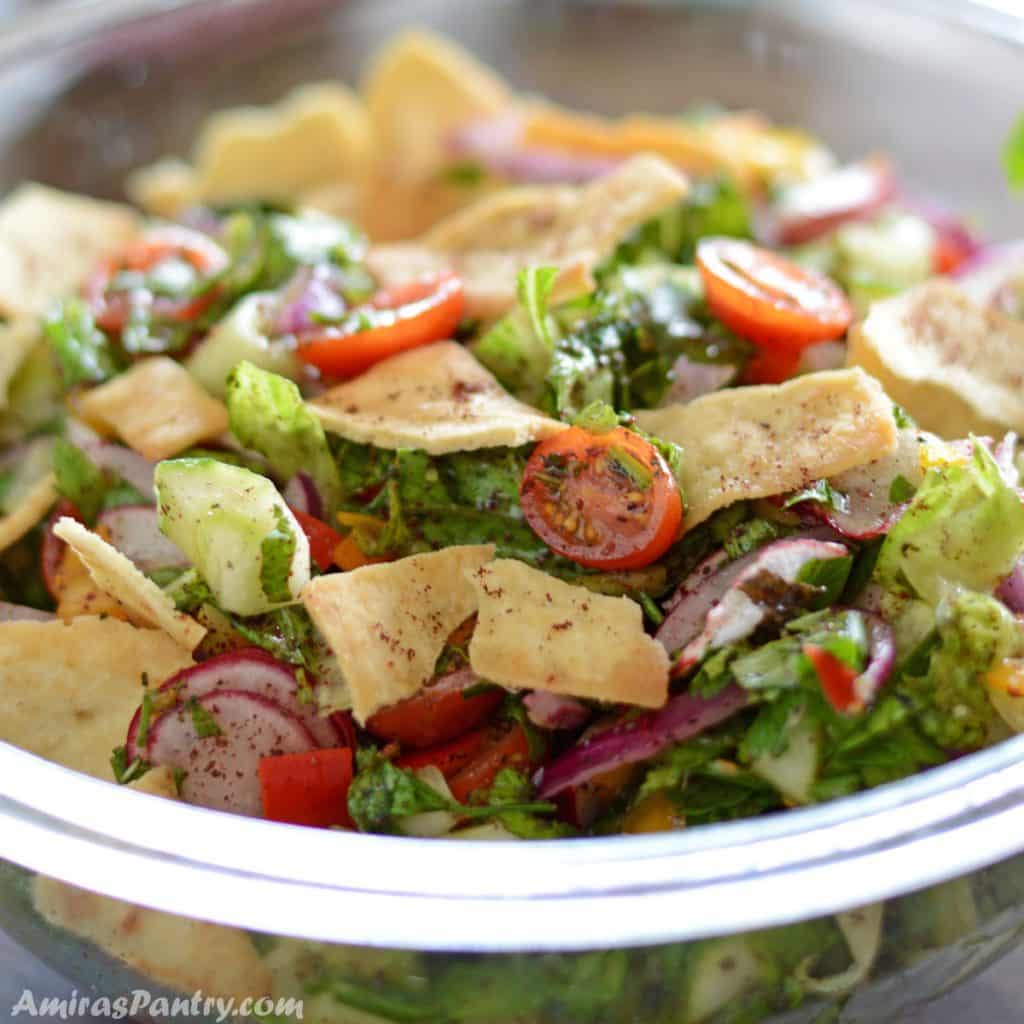 a close up to a salad bowl with bread on top.