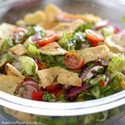 A close up to a salad bowl with bread on top.