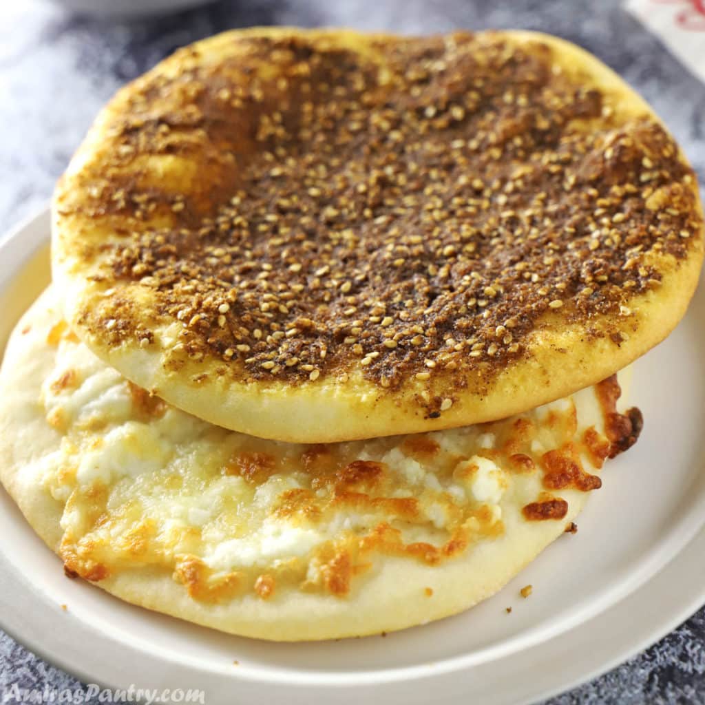 Za'atar and cheese manakeesh stacked on a light brown plate