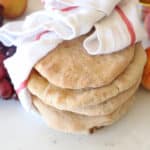 bread loaves wrapped in a white kitchen towel