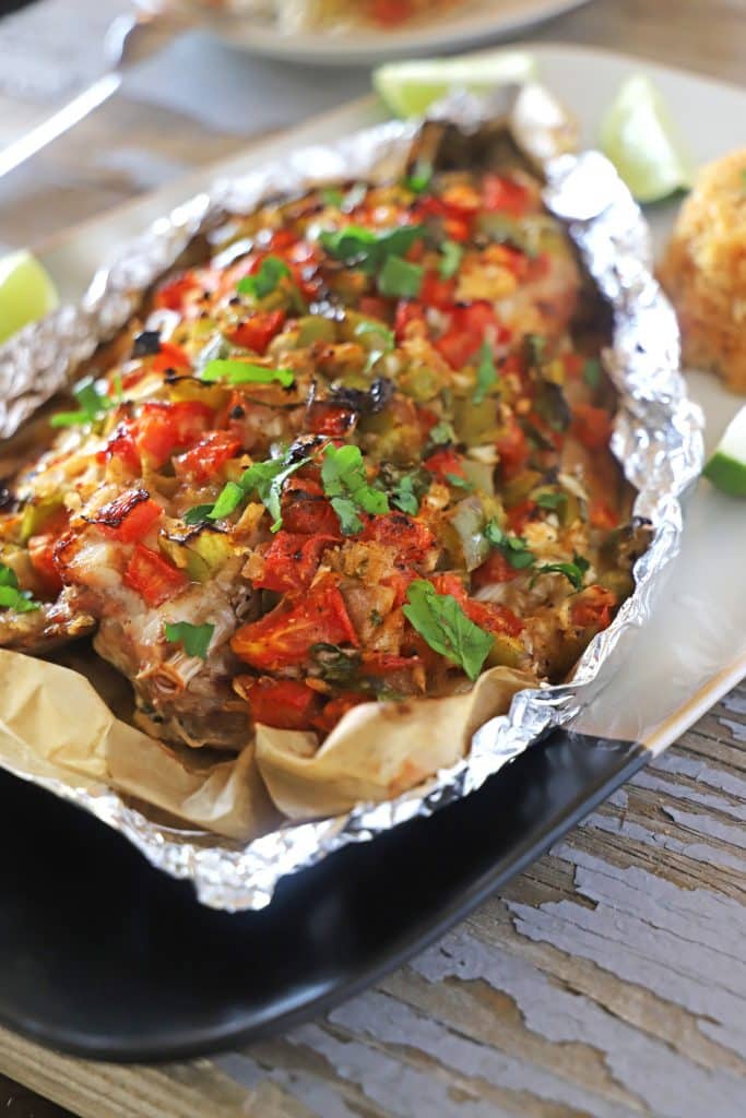 A close up of a plate of Sea Bass wrapped in Aluminum foil