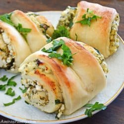 fatayer placed on a white serving plate and garnished with chopped parsley.