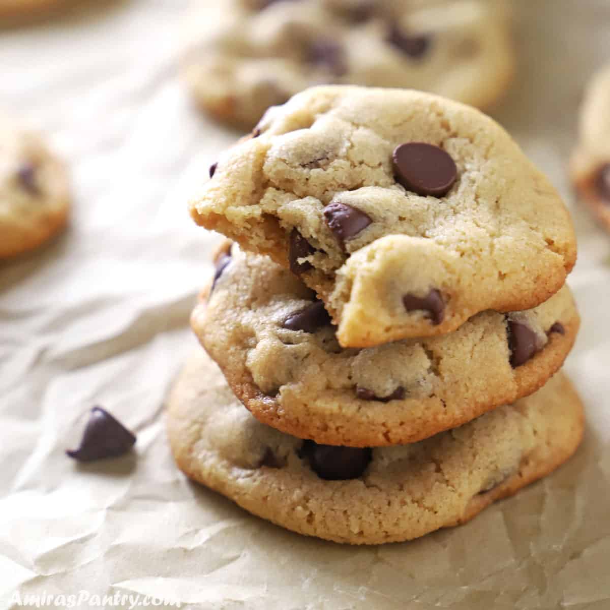 A stack of cookies with a bite taken from the top one.