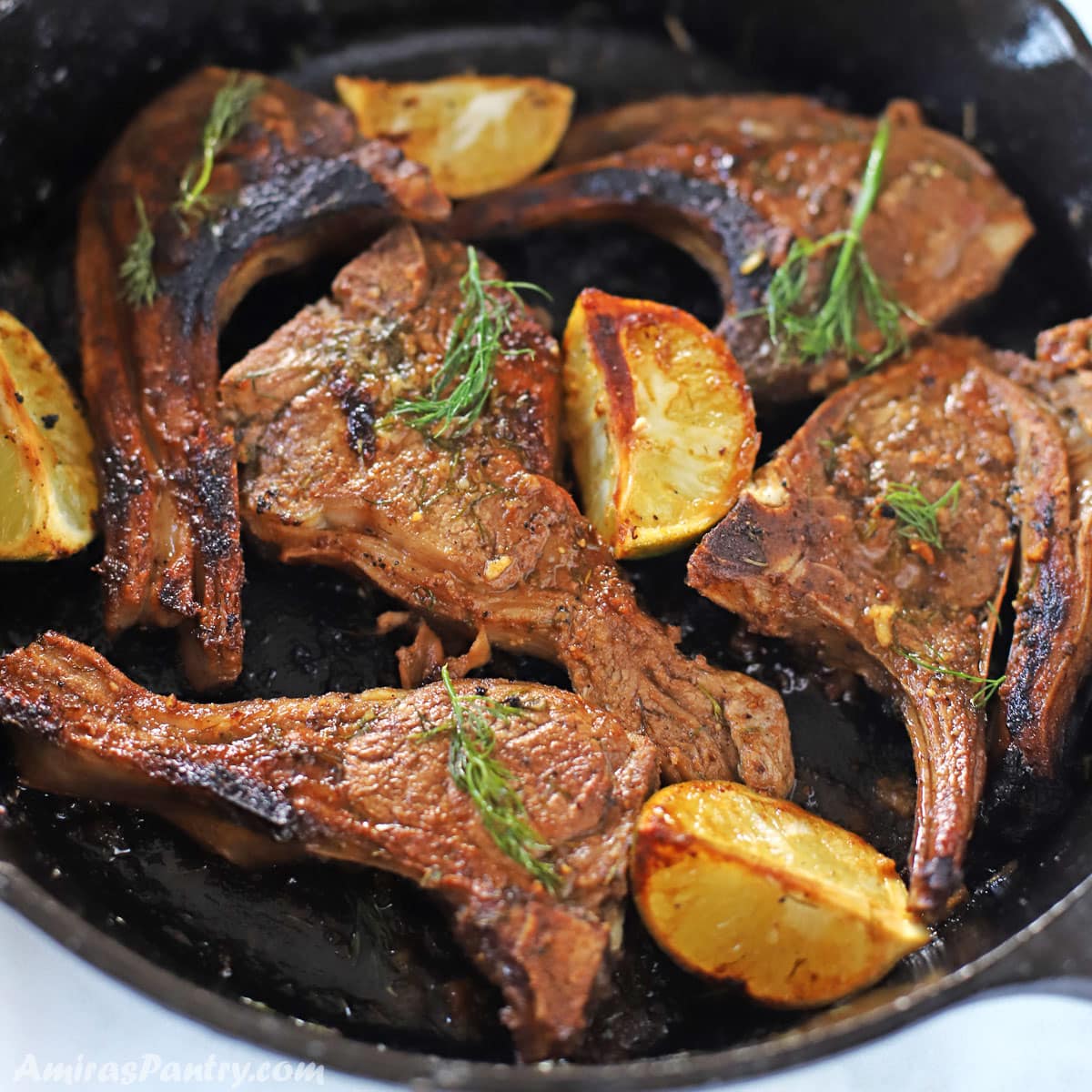 lamb chops on a cast iron skillet decorated with fresh dill and lemon wedges. Marinated Lamb Chops (Classic Middle Eastern Marinade) Marinated Lamb Chops (Classic Middle Eastern Marinade) lamb chops recipe I