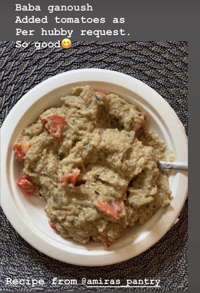 A plate of food on a table, with Baba ghanoush, made by a fan