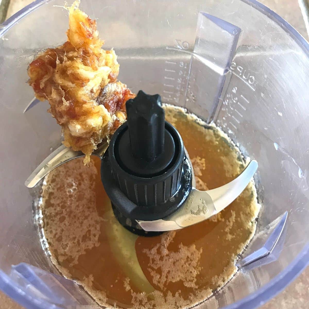 Step3 of making caramel: processing the hot syrup with date paste in a small food processor.