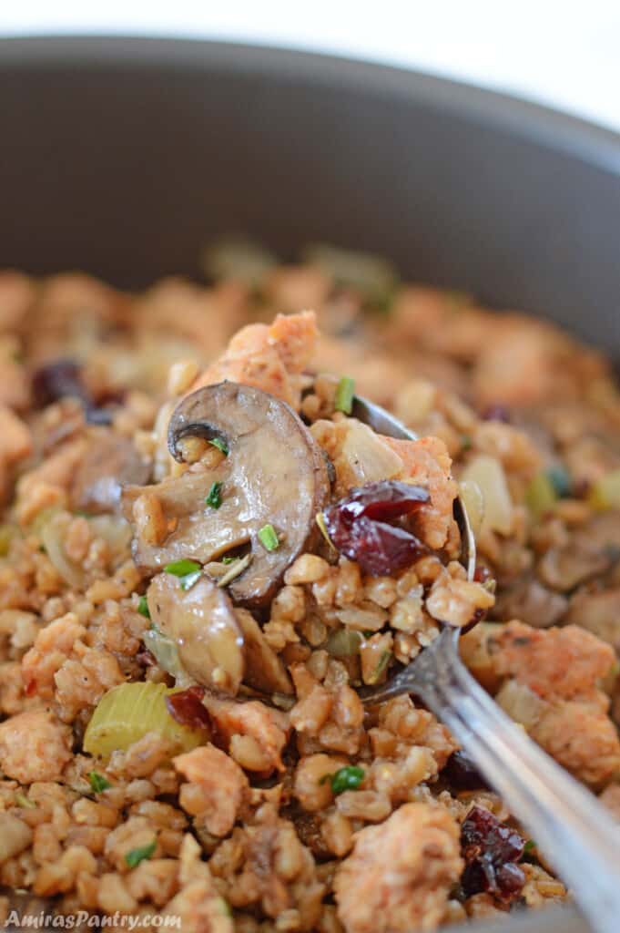 a spoon scooping some turkey sausage stuffing out of a pan. meal plan (76) - amira's pantry Meal Plan (76) &#8211; Amira&#8217;s Pantry turkey stuffing casserole II 681x1024