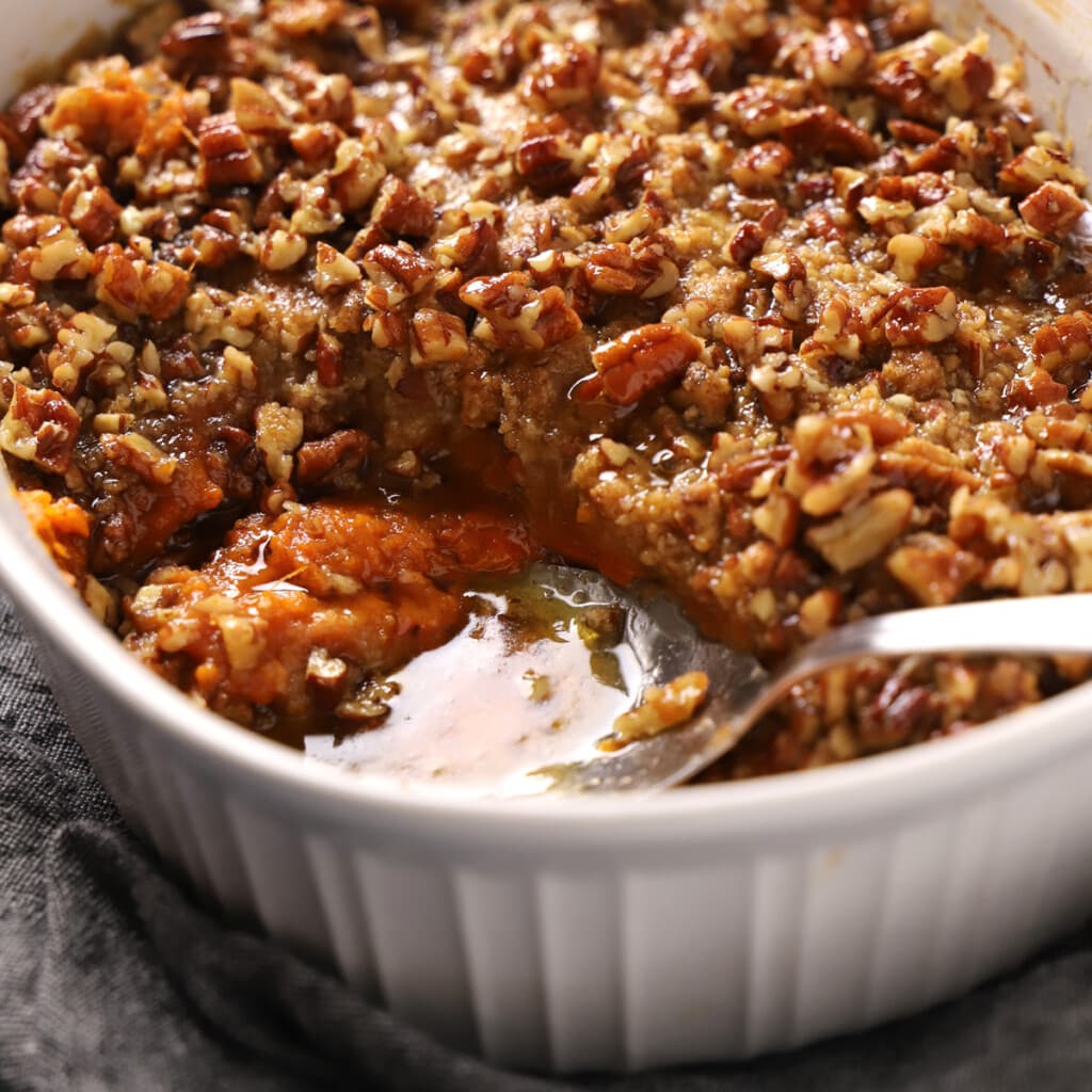 Close up of a spoon serving some sweet potato crunch.