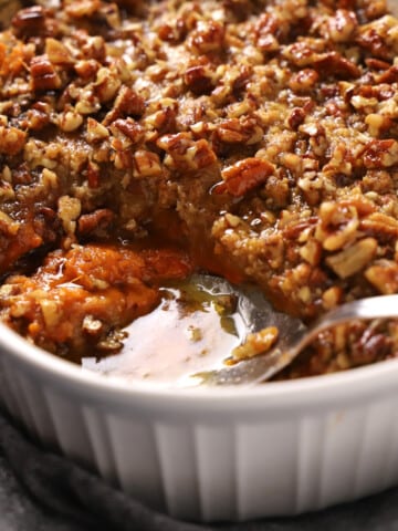 Close up of a spoon serving some sweet potato crunch.