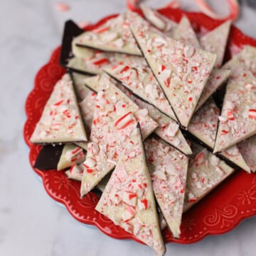 peppermint bark triangles on a red plate.