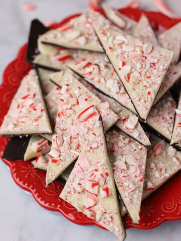 peppermint bark triangles on a red plate.