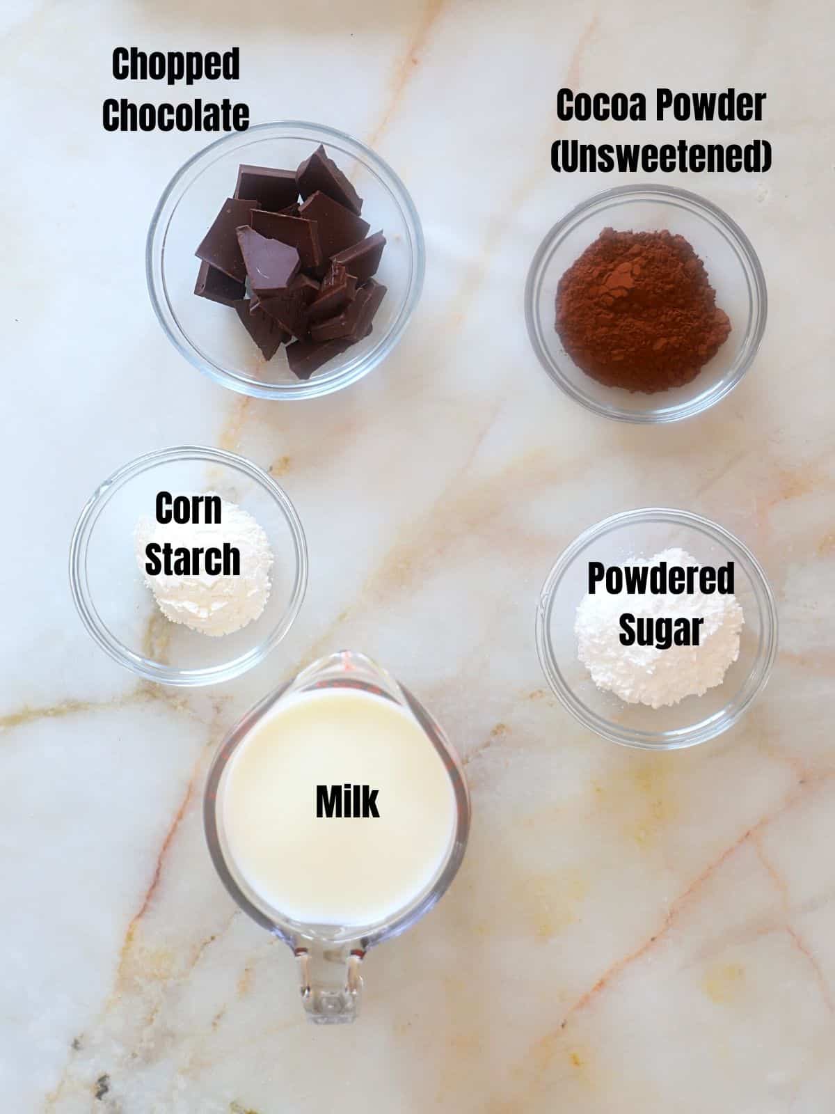 Italian hot chocolate ingredients on a marble table.