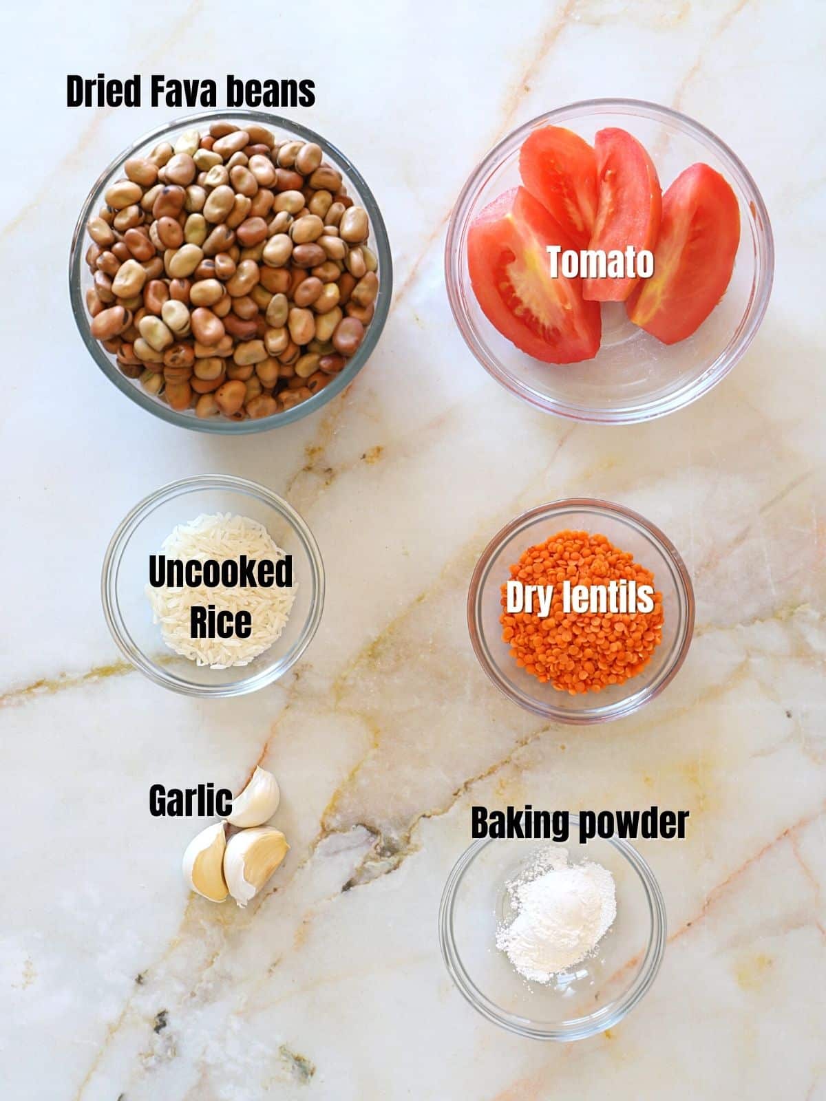 Ful Medames ingredients on a marble table top.