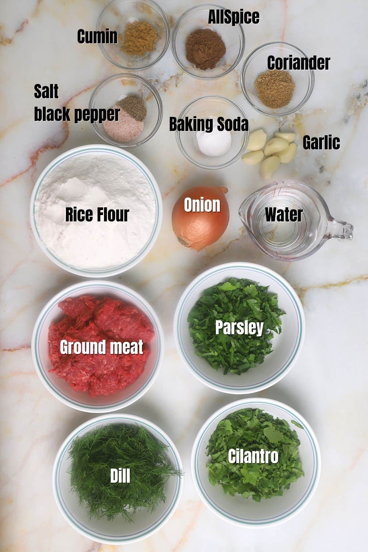 Ingredients for gluten free meatballs on a marble counter top.